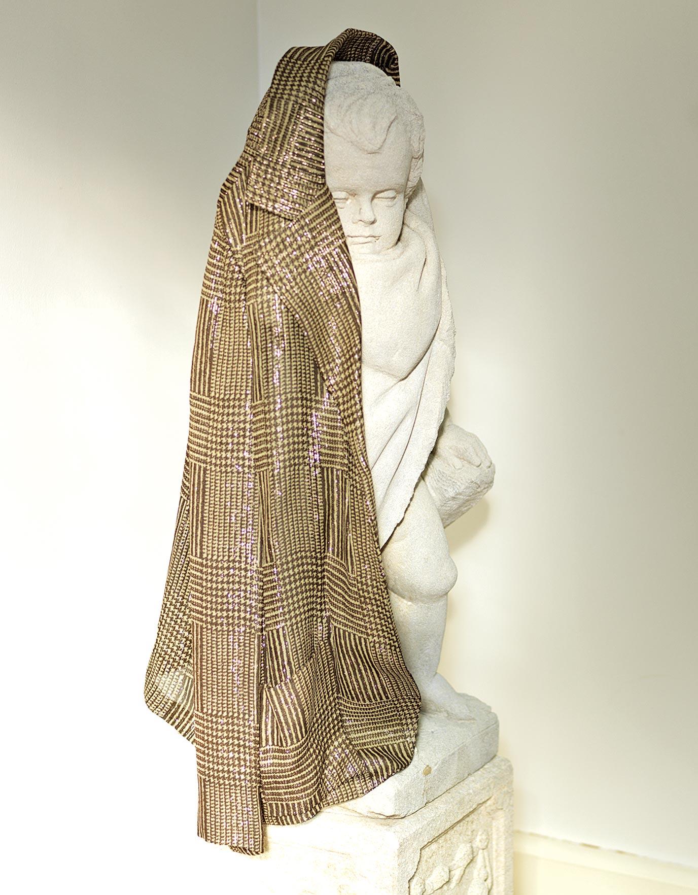 Gold jacket belonged to Ellie Montgomery draped over a statue in Ideas of Order Magazine