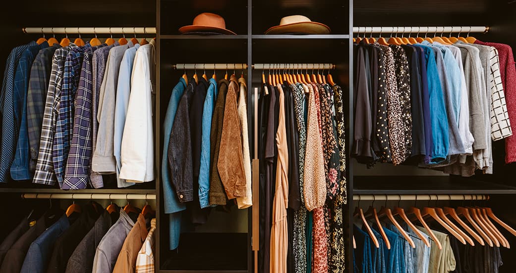 Walk in closet shelving, open storage, and hanging wardrobe space from California Closets