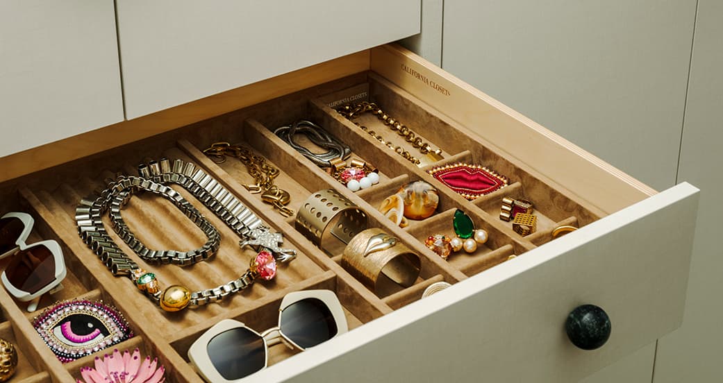 Custom drawer designed with jewelry dividers and cubbies from California Closets