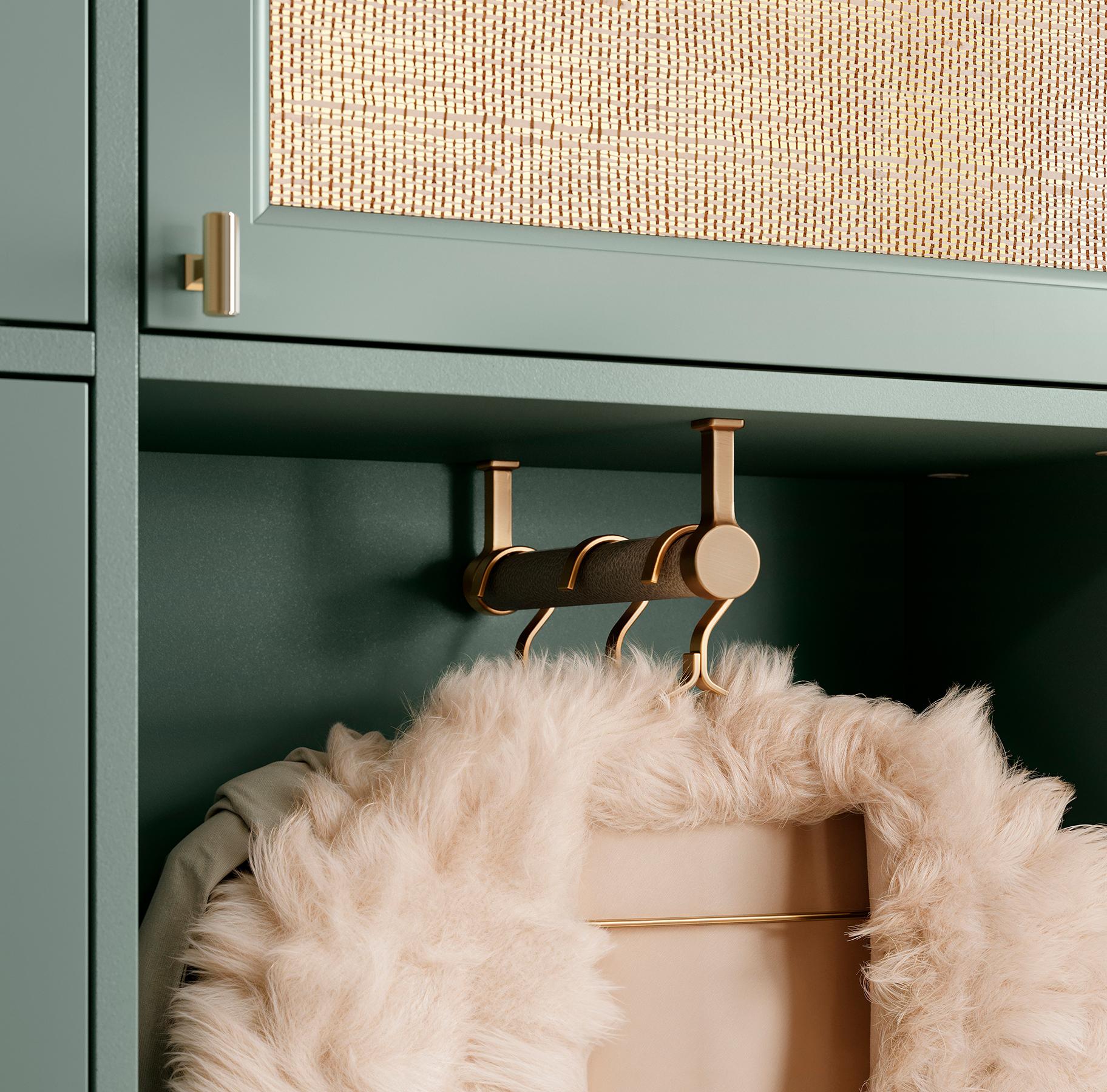 Laundry design with hanging clothing accessories in Desert Agave green finish from California Closets