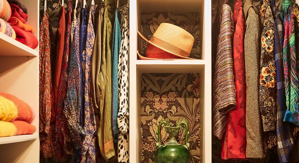 Walk-in closet organization designed with custom shelving from California Closets
