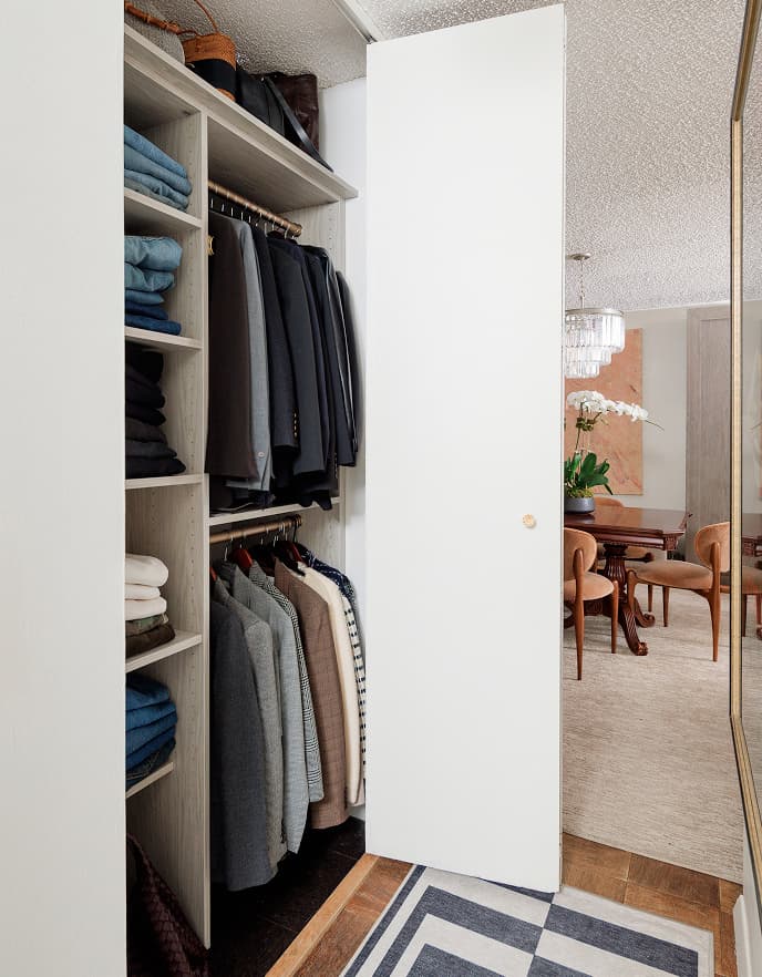 Custom reach-in closet with Wood Grain Grigio finish, gold hardware, and organized shoe shelving in New York City apartment