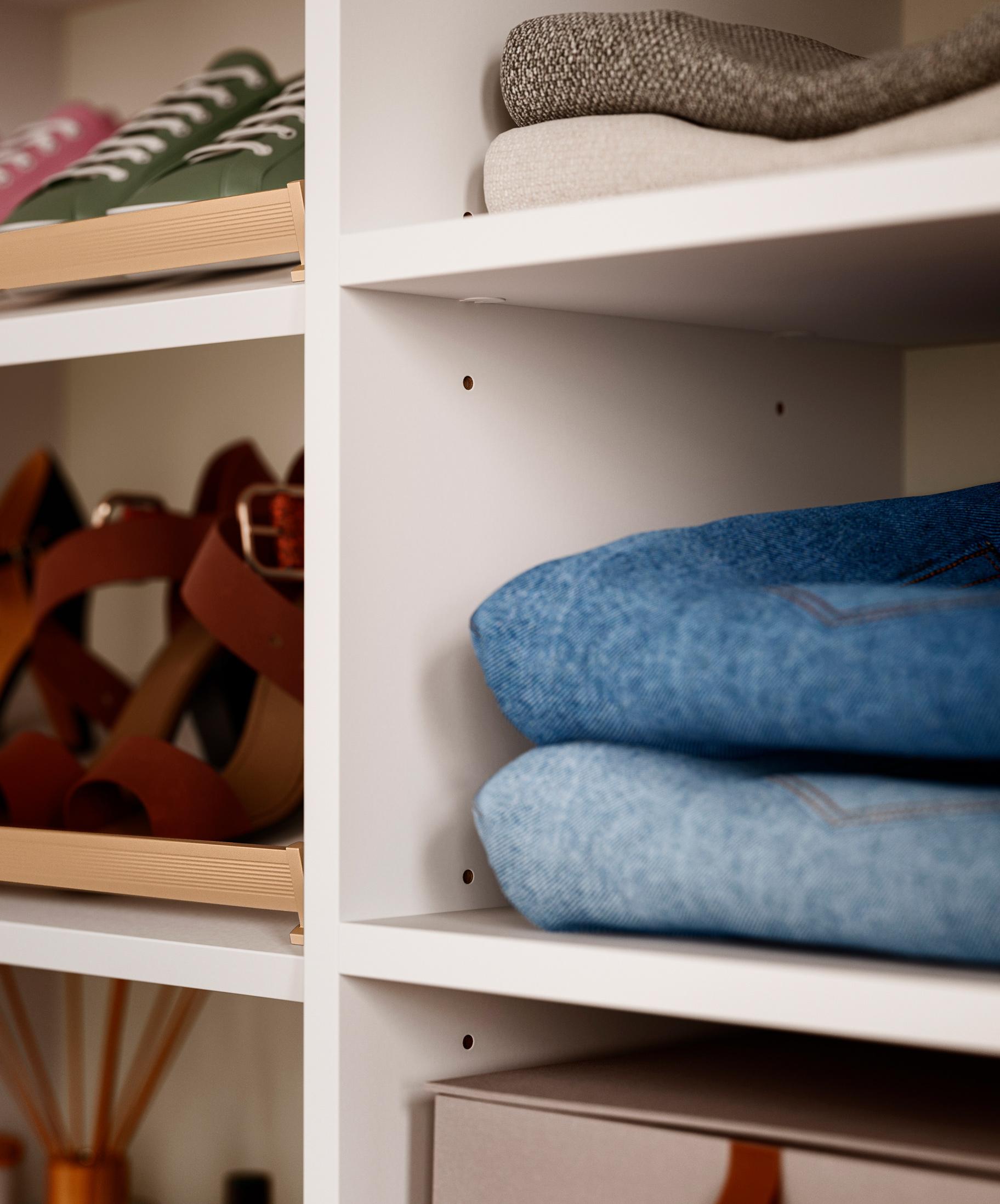 Custom closet drilling on partition walls allows adjustable shelving and hanging rods without visible hole rows, creating a clean, flexible built-in storage design by California Closets.