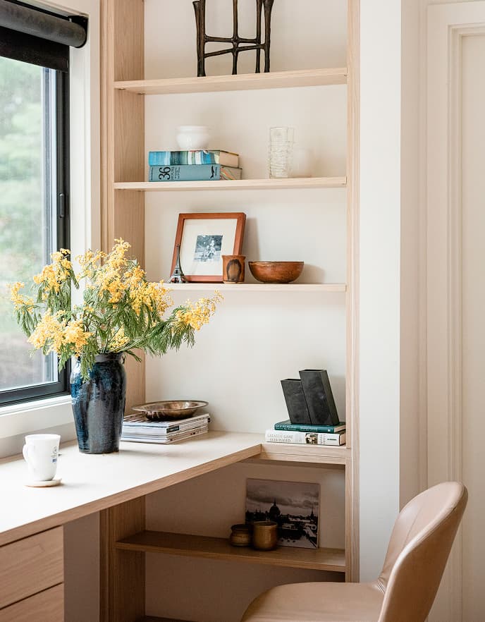Close-up of custom adjustable shelving and built-in desk organizer solutions by California Closets.