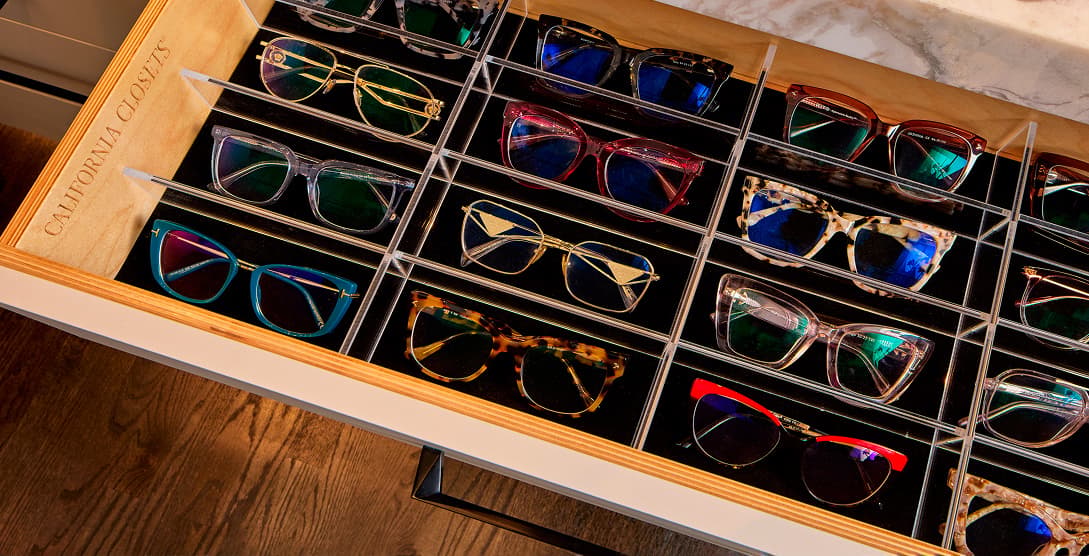 Custom drawer insert with acrylic dividers organizing sunglasses for LadySpineDoc by California Closets