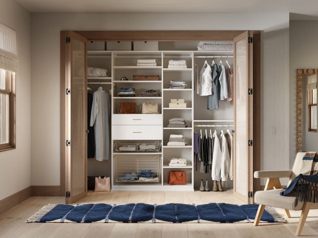 Custom drawers with open shelves and hanging space in reach in closet by California Closets
