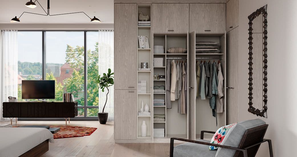 Space-saving custom wardrobe with mirrored doors and floor-to-ceiling storage for a small space.