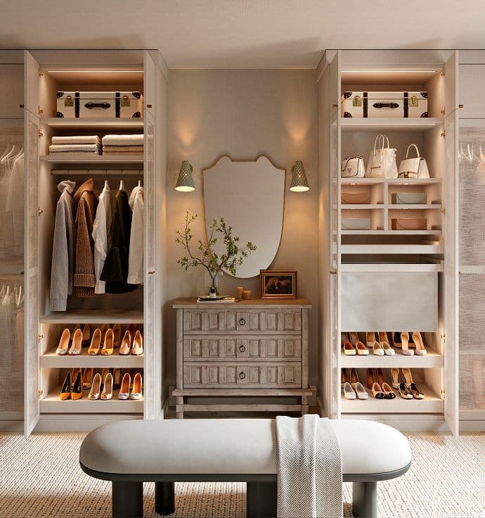 Walk in closet designed with custom cabinets, shoe storage, specialty lighting in light wood grain finish by California Closets