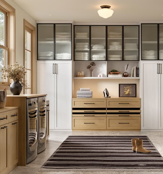 Storage cabinets and countertop designed for a custom laundry room designed by California Closets
