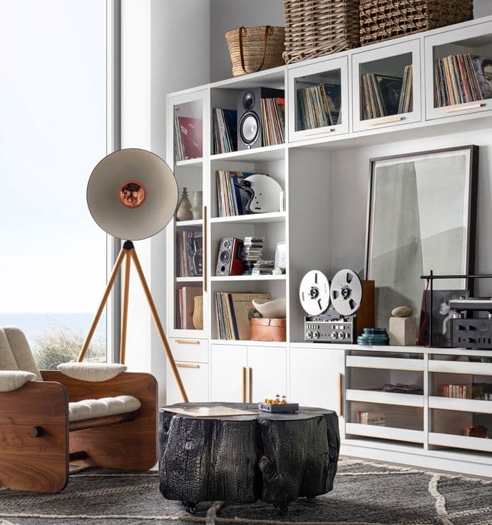 Living room storage shelving aroud an entertainment center with custom shelves and cabinets by California Closets