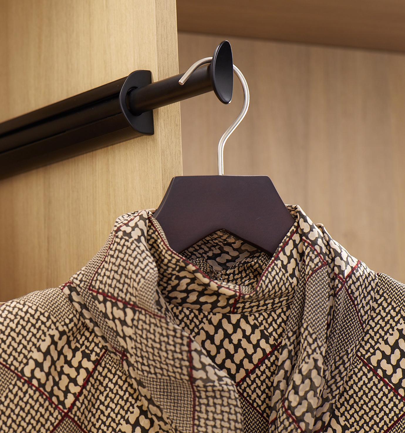 Custom Wardrobe closet with customized shelves and valet rod by California Closets