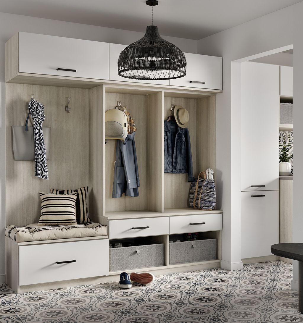Professionally installed custom mudroom storage with bench, cabinets, drawers and hooks by California Closets