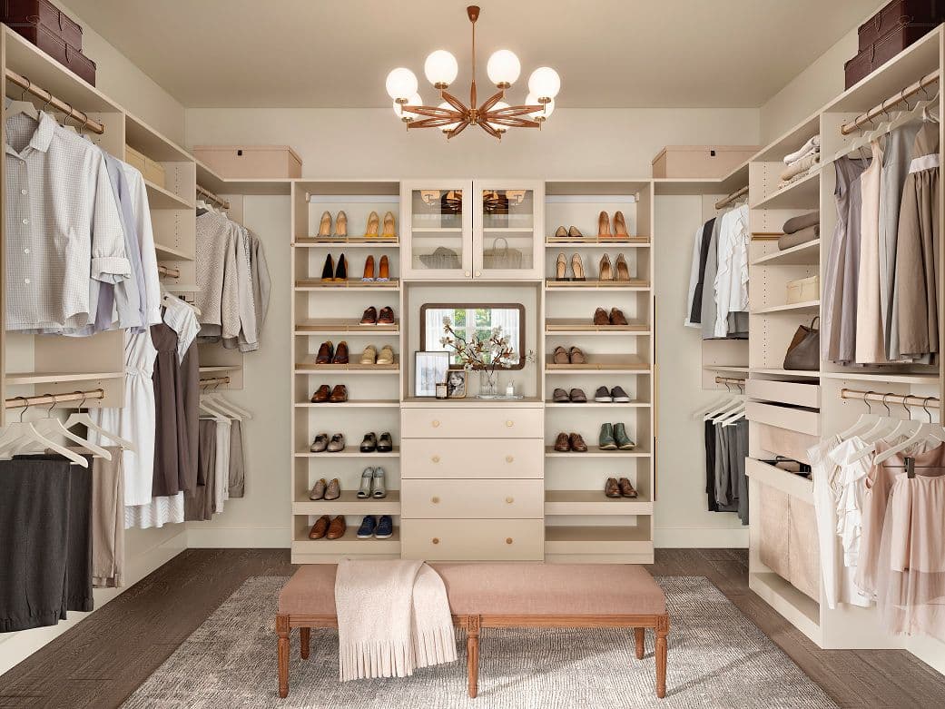 Shoe shelving with open design walk in closet suspended off floor with flat drawers, and storage baskets by California Closets